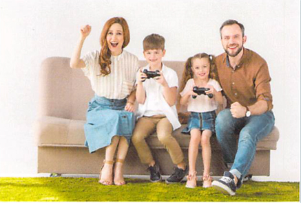 Family playing video games on a couch
